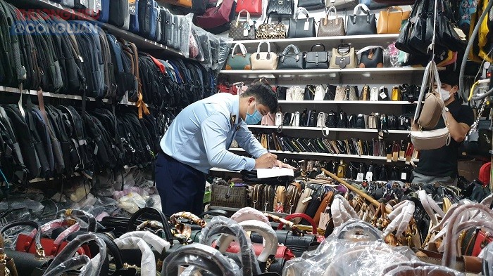 Nhiêu túi sách, ví da, balo mang nhãn hiệu Louis Vuitton, Adidas được bày bán công khai tại chợ Hà Đông
