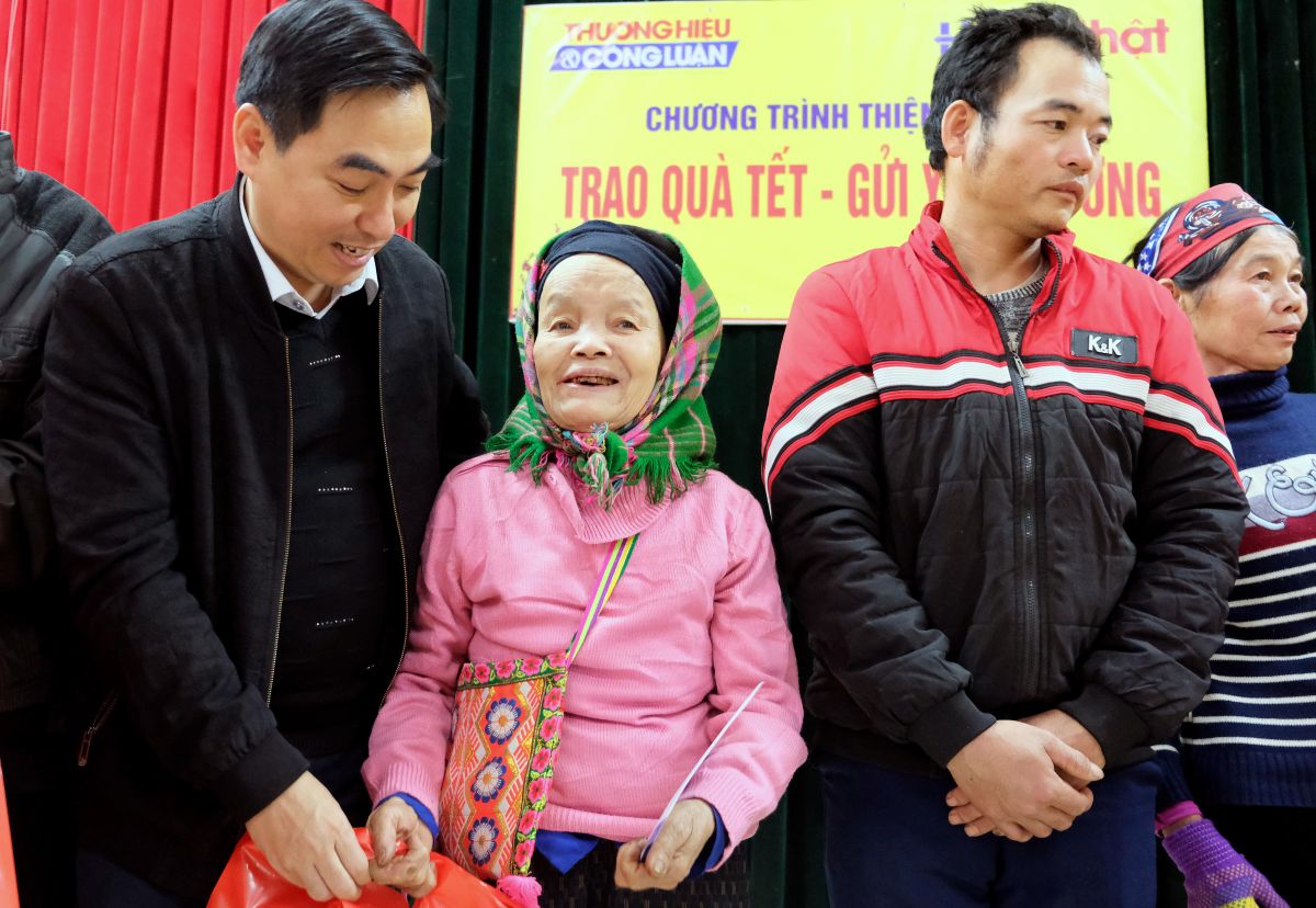 Ông Trần Tiến Hưng - Trưởng ban Tuyên giáo Huyện ủy Lục Yên - chia sẻ niềm vui với các hộ dân được nhận quà Tết.