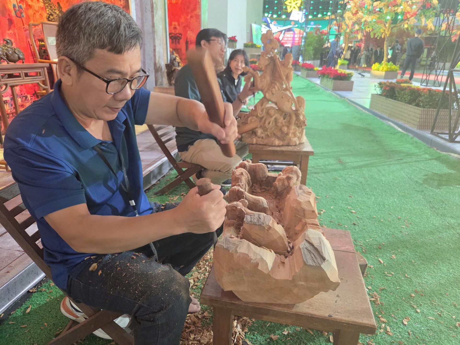 Nghệ nhân điêu khắc gỗ chăm chú tạo hình trên khối gỗ lớn - mỗi nhát đục là một nét hồn của nghề. Nghệ nhân điêu khắc gỗ chăm chú tạo hình trên khối gỗ lớn - mỗi nhát đục là một nét hồn của nghề.