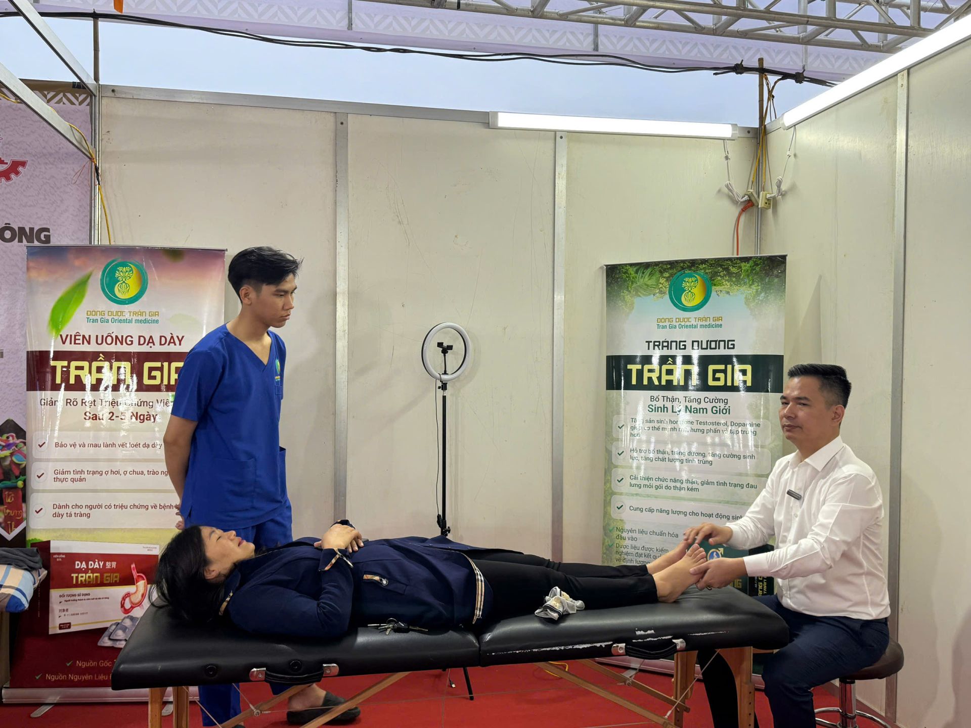 Bác sĩ Trần Văn Võ đang trị liệu cho một khách tham quan gian hàng.