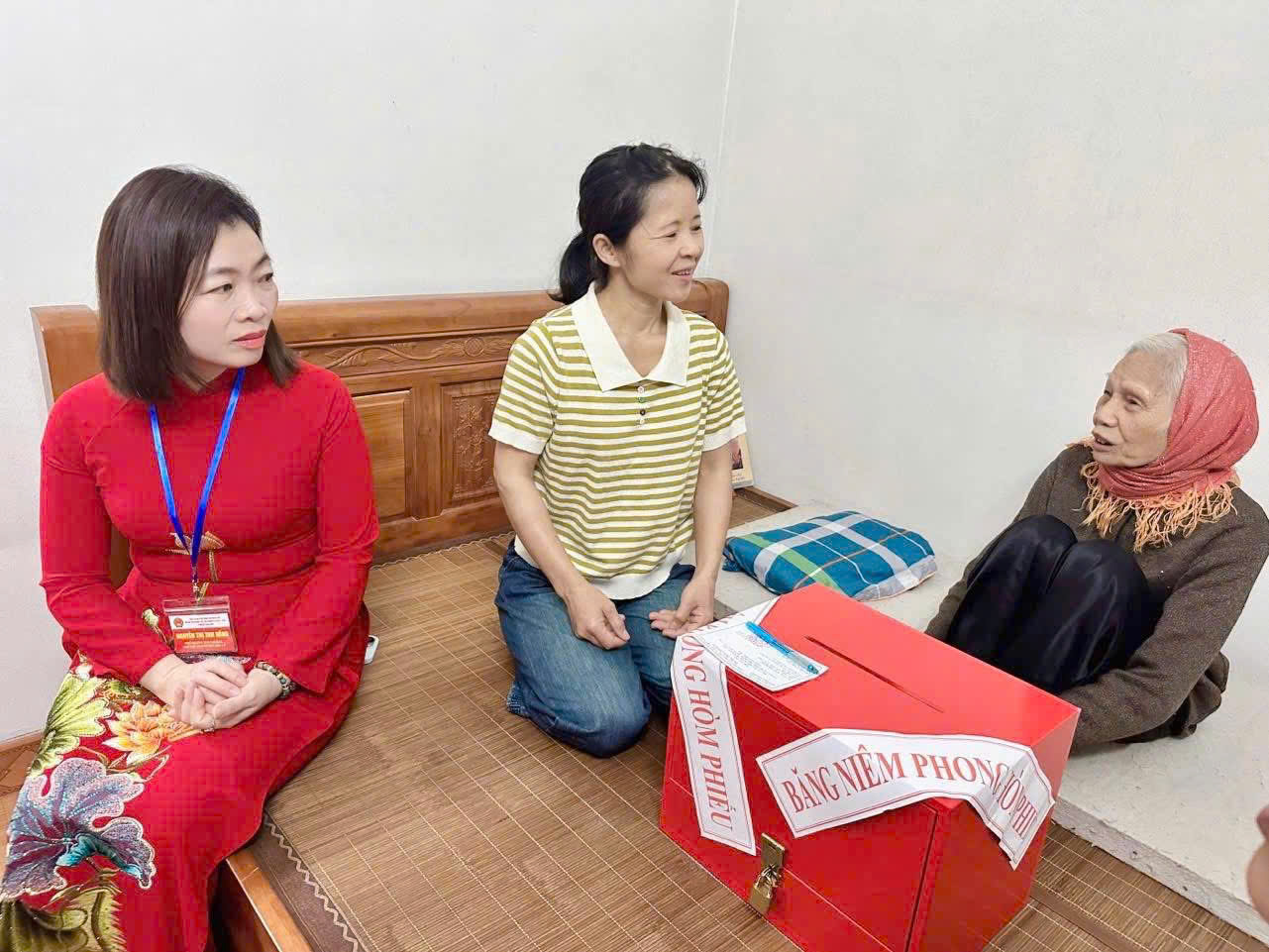 Tổ bầu cử mang h&ograve;m phiếu phụ đến hỗ trợ cử tri cao tuổi thực hiện quyền bầu cử tại nơi cư tr&uacute;.